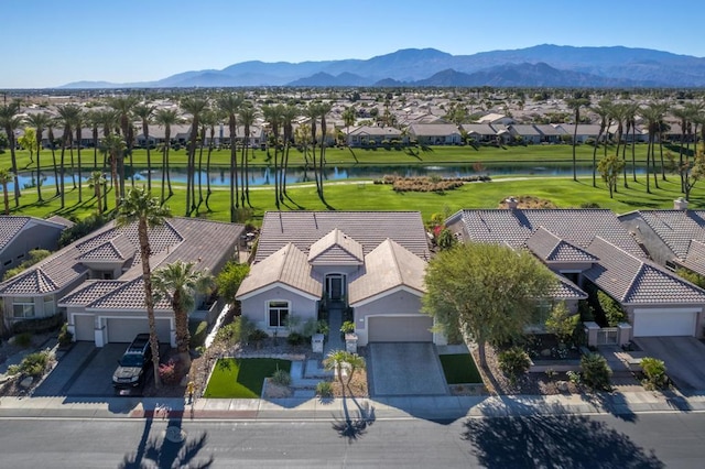 bird's eye view with a water and mountain view