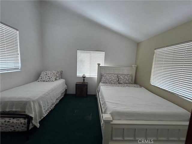 bedroom featuring dark carpet and lofted ceiling