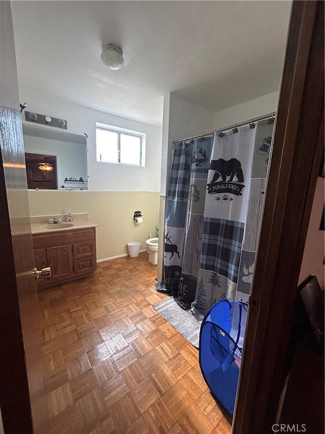 bathroom with vanity, toilet, a bidet, and curtained shower