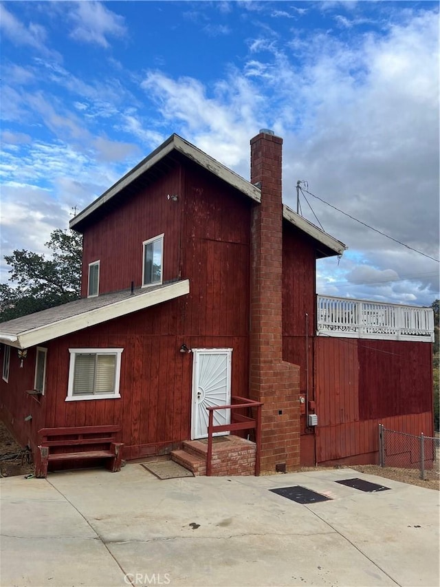 rear view of property featuring a patio area