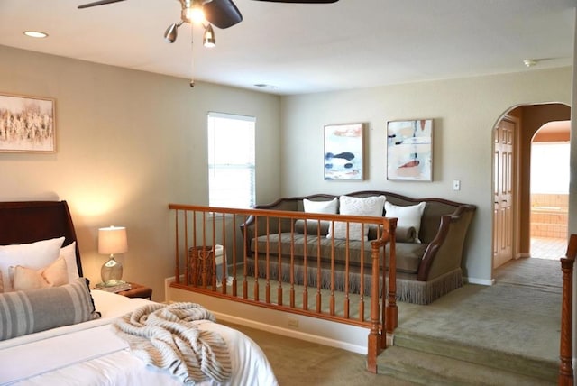 carpeted bedroom featuring ceiling fan and ensuite bath