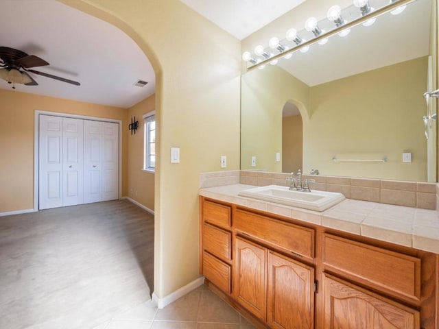 bathroom with tile patterned flooring, ceiling fan, and vanity