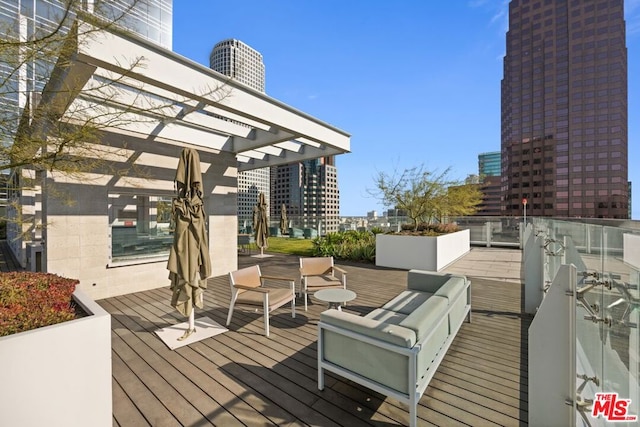 wooden deck with a pergola and outdoor lounge area