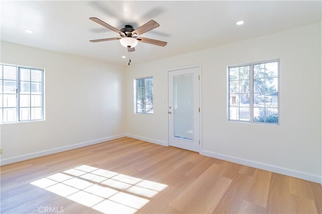 unfurnished room with light wood-type flooring, ceiling fan, and a healthy amount of sunlight