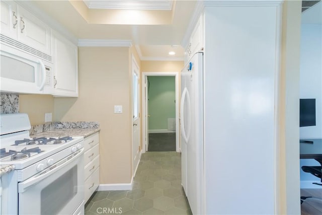 kitchen featuring light stone counters, white appliances, crown molding, dark tile patterned flooring, and white cabinets