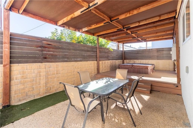 view of patio / terrace with a hot tub