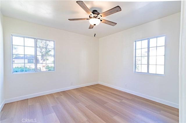 empty room featuring ceiling fan and light hardwood / wood-style floors