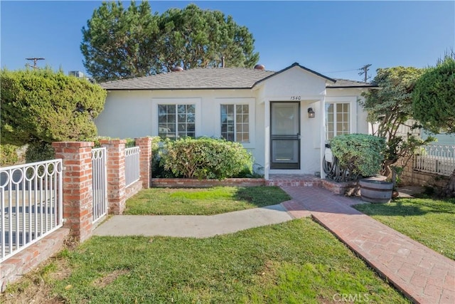 bungalow-style house with a front lawn