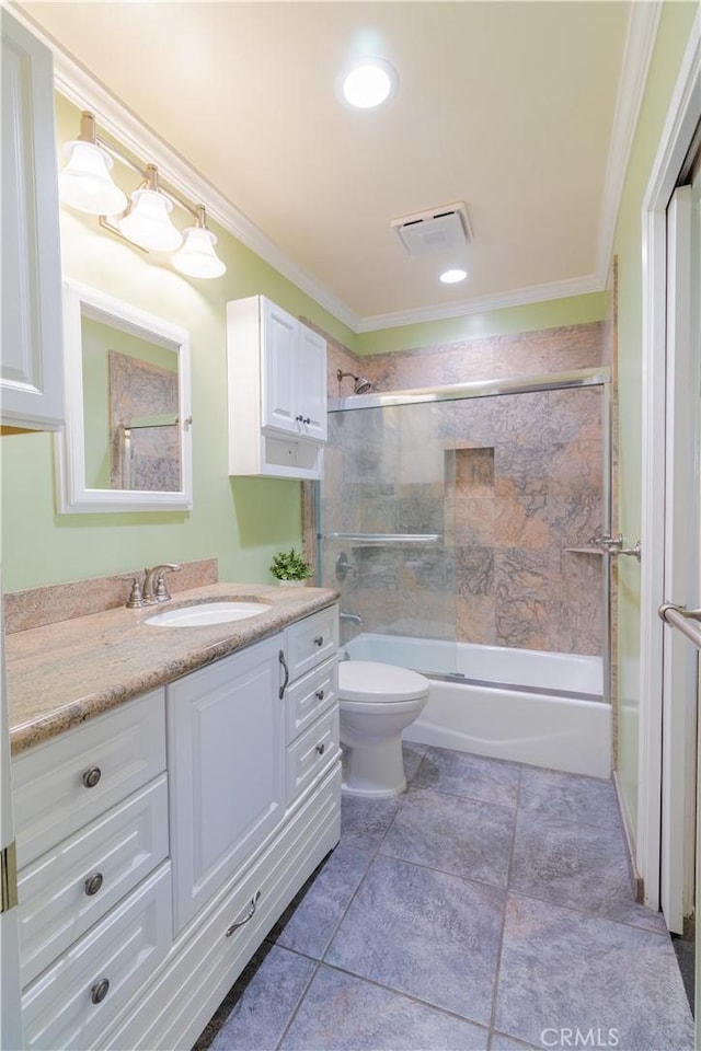 full bathroom featuring vanity, tile patterned floors, bath / shower combo with glass door, toilet, and ornamental molding