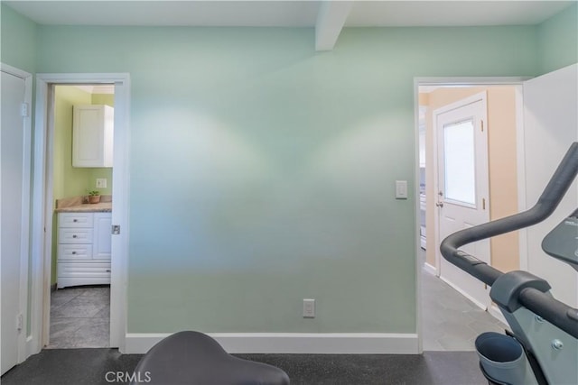 exercise room with light tile patterned floors