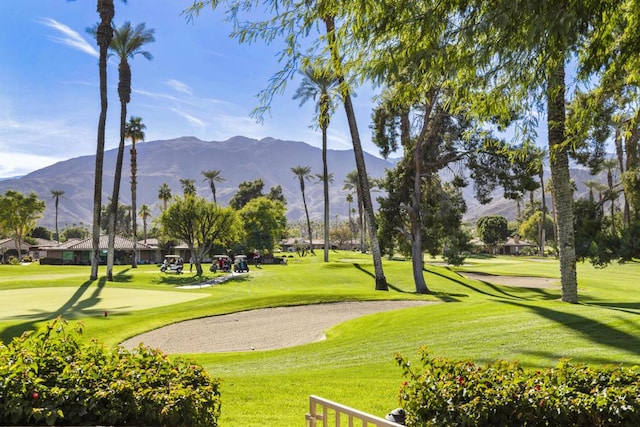 surrounding community with a lawn and a mountain view