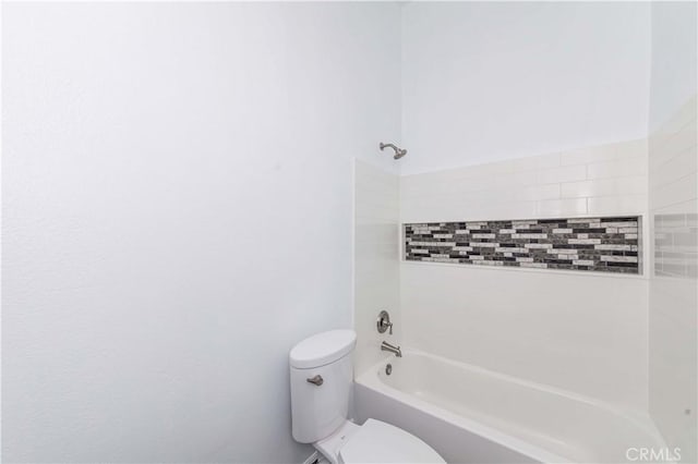 bathroom featuring toilet and tiled shower / bath combo