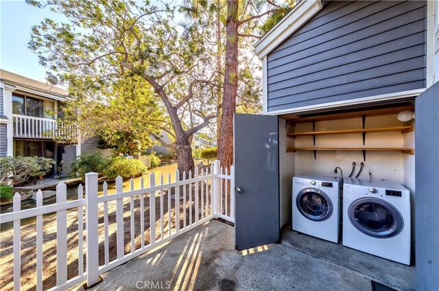 clothes washing area with washer and dryer