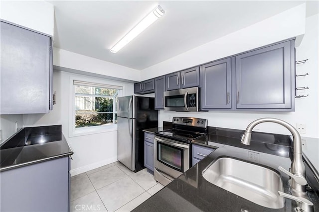 kitchen featuring sink, light tile patterned floors, and stainless steel appliances