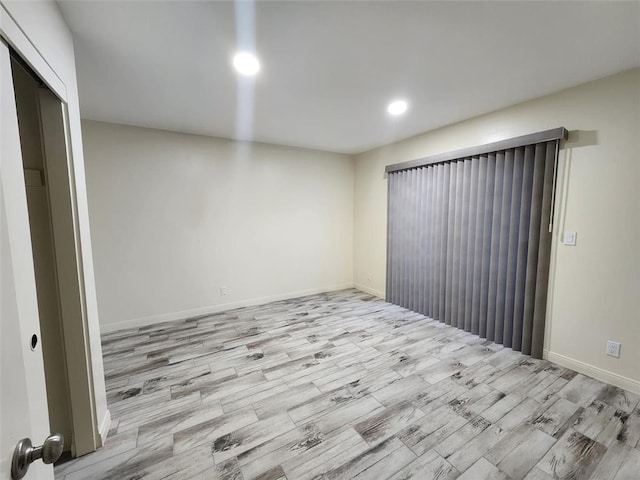 spare room featuring light hardwood / wood-style floors