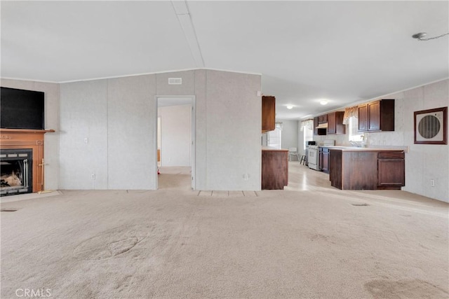 unfurnished living room featuring light colored carpet and lofted ceiling