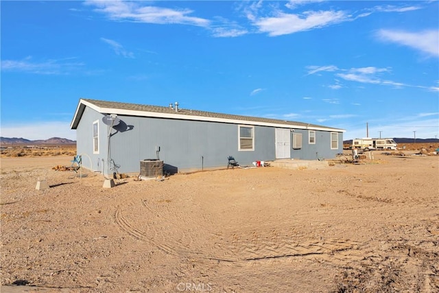 back of property featuring a mountain view