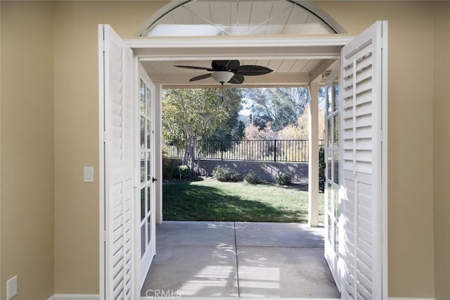 doorway to outside with ceiling fan, concrete flooring, and a healthy amount of sunlight