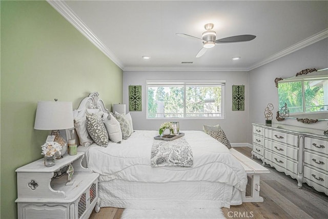 bedroom with ceiling fan, crown molding, and hardwood / wood-style floors