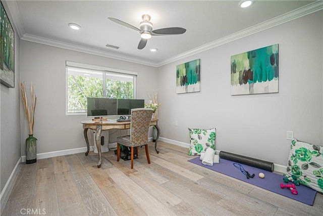 home office with ceiling fan, crown molding, and light wood-type flooring