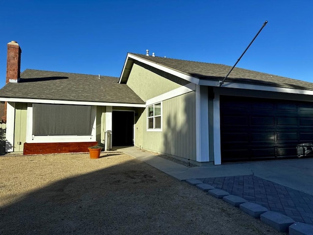 back of house featuring a garage