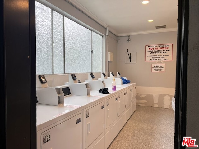 interior space featuring washing machine and clothes dryer, a healthy amount of sunlight, and ornamental molding