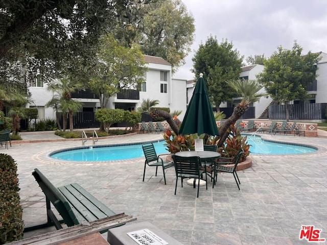 view of pool featuring a patio