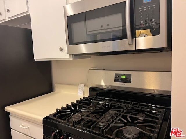 kitchen featuring white cabinets and appliances with stainless steel finishes