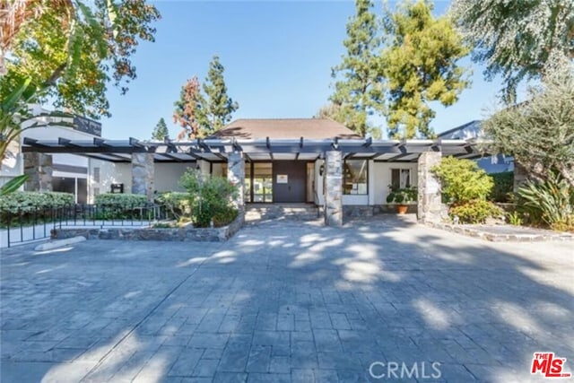 view of front of home with a pergola and a patio area