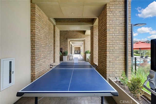 game room with brick wall