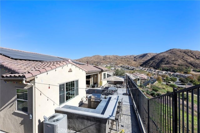 exterior space with a mountain view and cooling unit