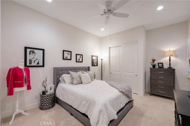 bedroom with light carpet, a closet, and ceiling fan