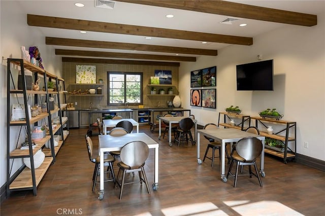 dining room with dark hardwood / wood-style flooring and beamed ceiling