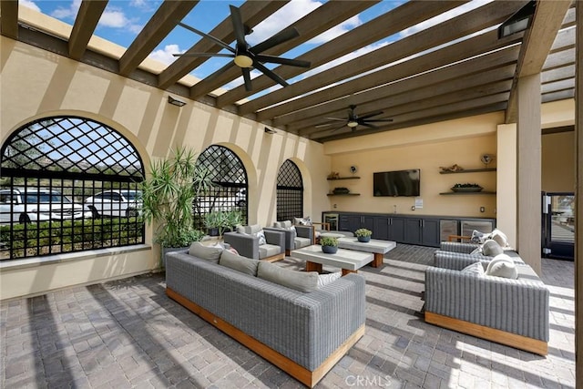 view of patio / terrace with a pergola, ceiling fan, exterior kitchen, and an outdoor hangout area