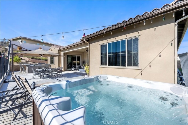 view of pool with a patio area and a hot tub