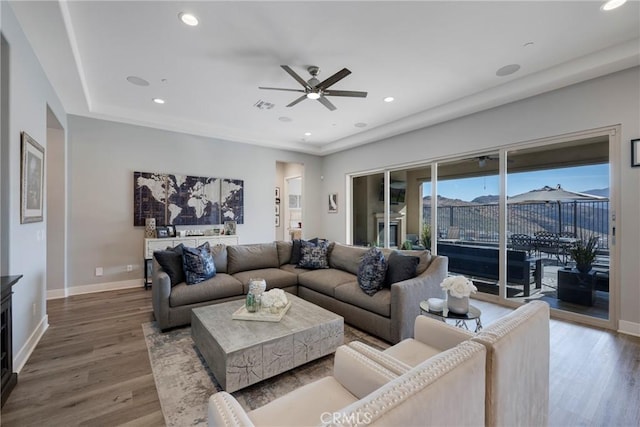 living room with hardwood / wood-style flooring and ceiling fan