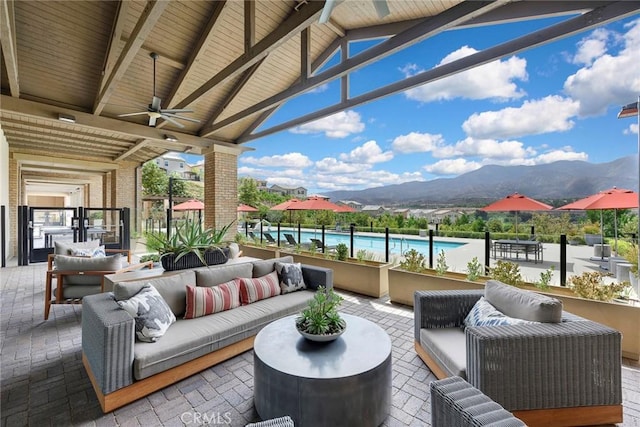 view of patio / terrace featuring a mountain view, an outdoor hangout area, and ceiling fan