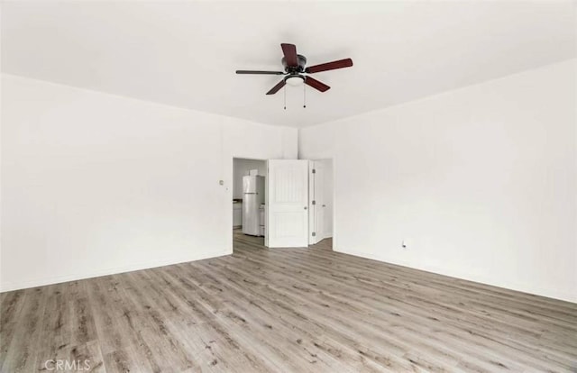 unfurnished room featuring ceiling fan and light hardwood / wood-style floors