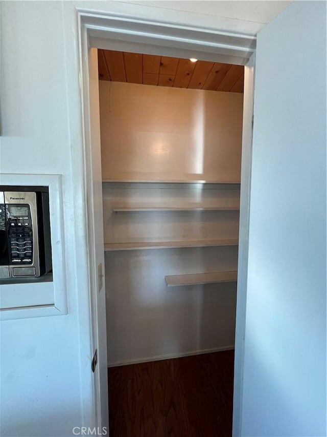 interior details with wood ceiling and hardwood / wood-style flooring