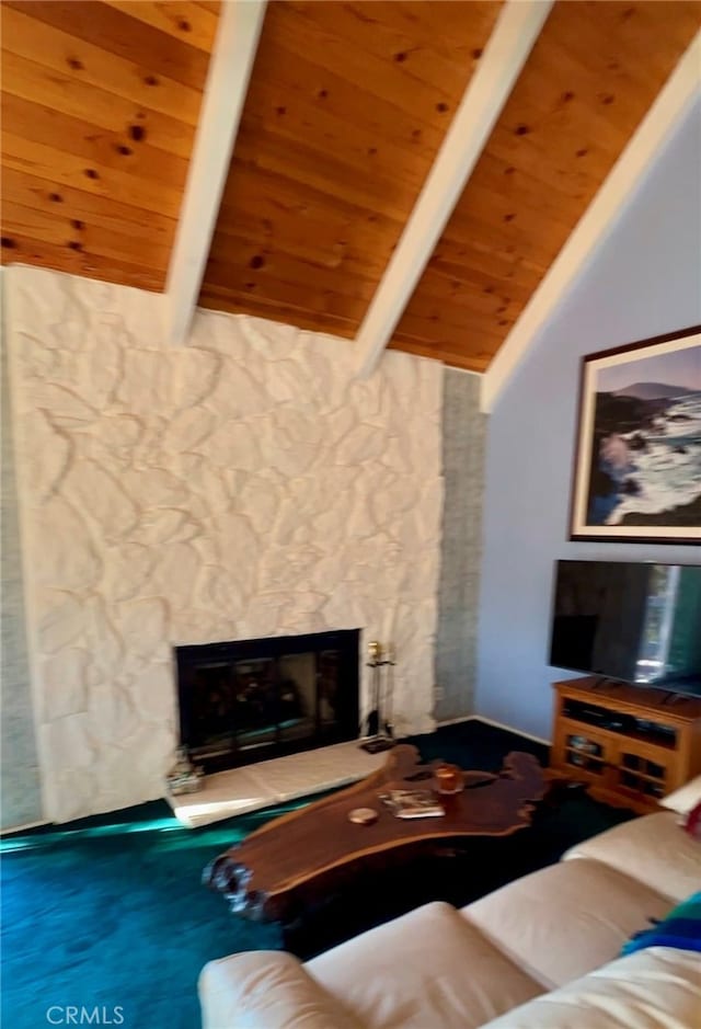 living room with a stone fireplace, wood ceiling, and vaulted ceiling with beams