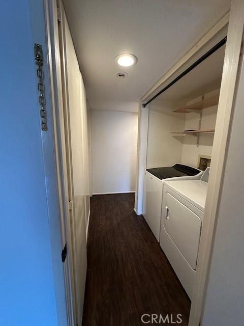 clothes washing area with dark hardwood / wood-style floors and washing machine and clothes dryer