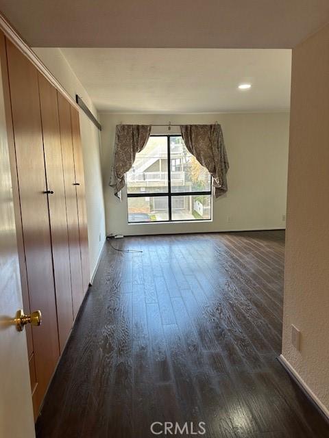 unfurnished room with dark hardwood / wood-style floors