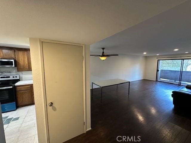 unfurnished living room with ceiling fan and light hardwood / wood-style flooring