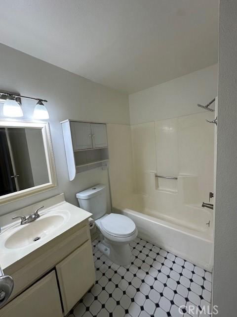 full bathroom with vanity, toilet, and washtub / shower combination