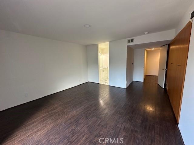 unfurnished room featuring dark hardwood / wood-style flooring