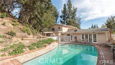 view of pool with french doors