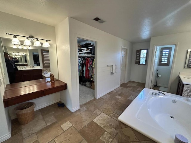 bathroom with a bath and vanity