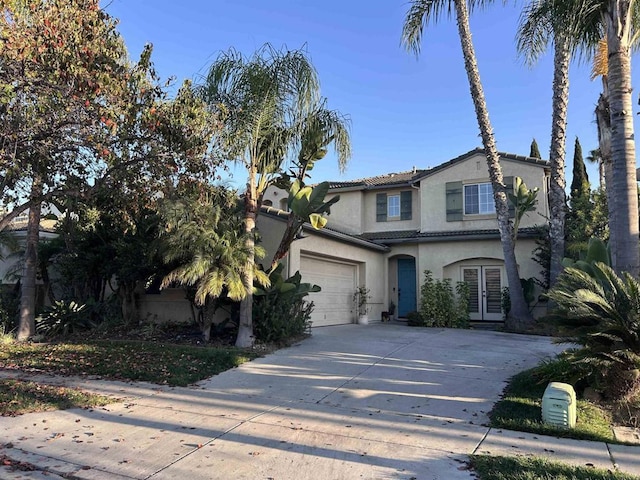 view of front of home with a garage and french doors