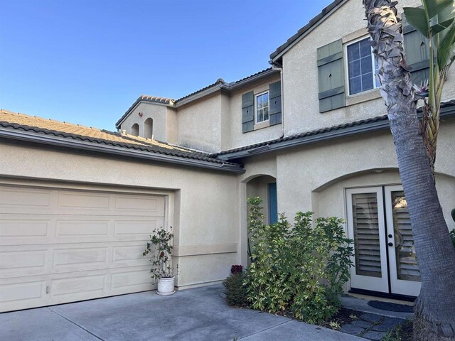 view of front of property featuring french doors and a garage