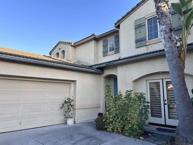 view of front of house with a garage and french doors